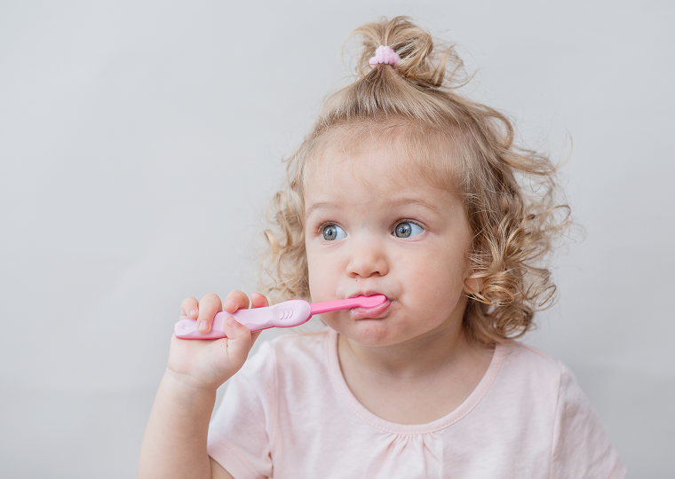 curly beautiful baby girl white dress with toothbrush 1