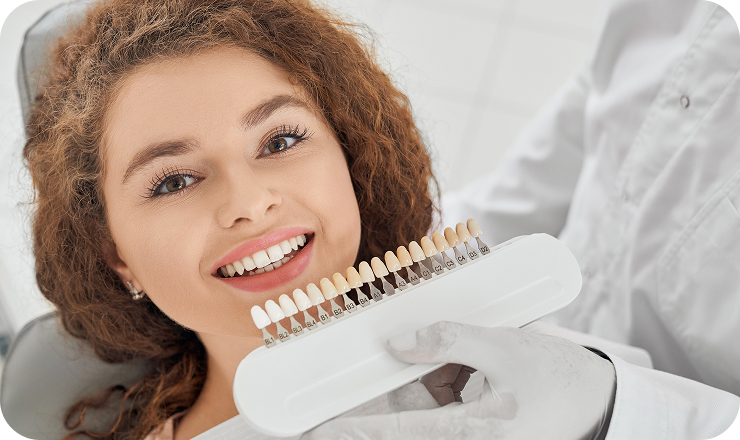 woman smiling while male dentist keeping teeth color range 1